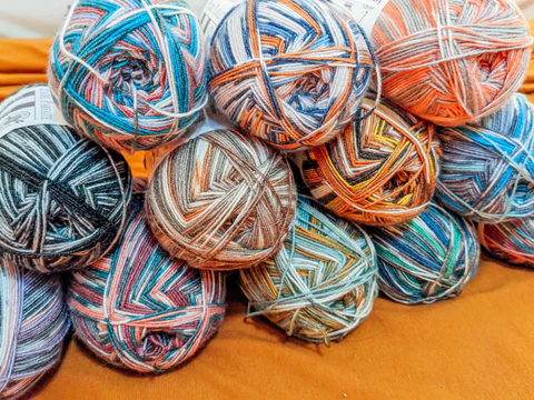 Loops and Threads yarn collection featuring vibrant colorful skeins for knitting and crochet
